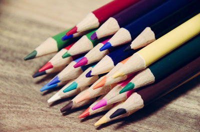 Close-up of colored pencils arranged on table