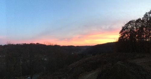 Scenic view of silhouette mountains against sky at sunset