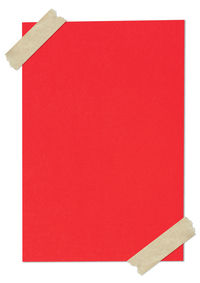 Close-up of red paper over white background