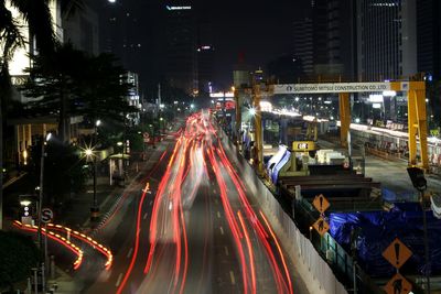 High angle view of light trails on road at night