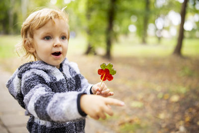Portrait of cute girl holding flower