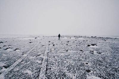 Distant view of people on beach during winter