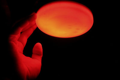 Close-up of light bulb over black background