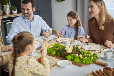 Portrait of friends having food at home