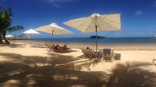 People on beach against sky