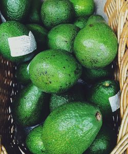 High angle view of avocados in basket at market