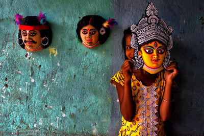 Portrait of girl wearing goddess mask