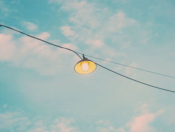 Low angle view of light bulb against sky