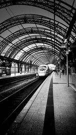 Train at railroad station against sky