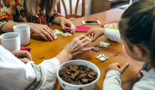 Family playing dominos at table