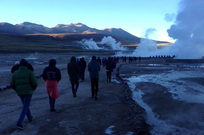 People against volcano landscape