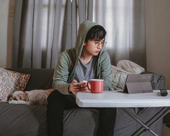 Young woman sitting at home