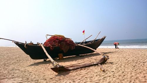 People on beach against clear sky