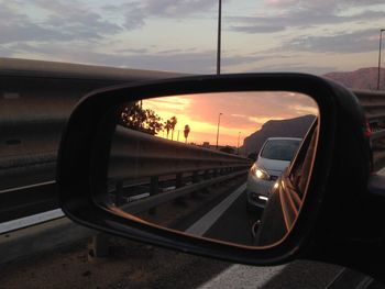 Car on road against sky during sunset