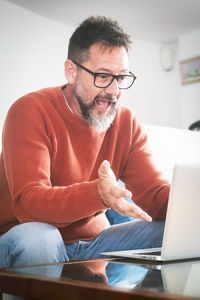 Young man using laptop at home