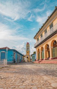 Buildings in city against cloudy sky