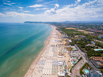 High angle view of city by sea against sky