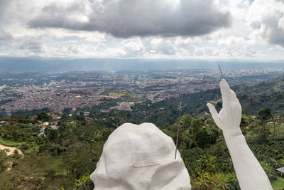 Statue of buildings against cloudy sky