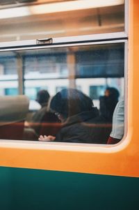 People seen through train window