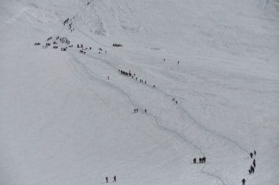 High angle view of people on snow covered landscape