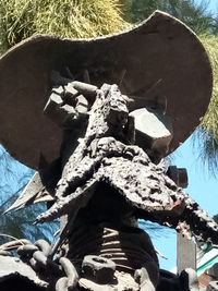 Low angle view of statue against trees