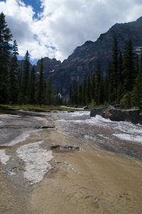 Scenic view of river and mountains against sky