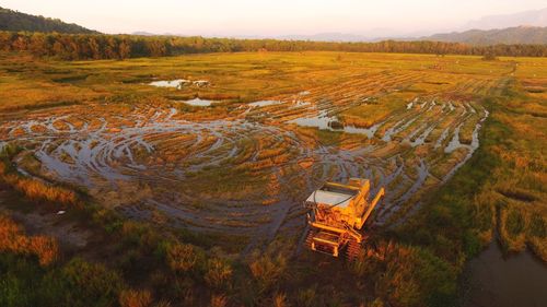 High angle view of agricultural field against sky during sunset