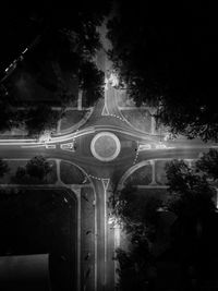 Low angle view of illuminated road against sky at night