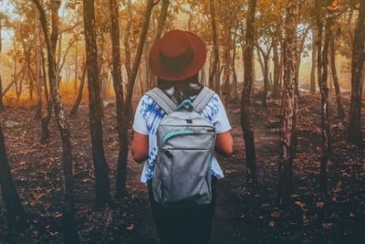 Man standing by trees in forest during autumn