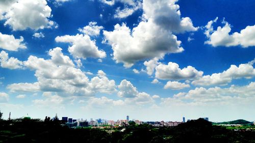 Panoramic shot of cityscape against blue sky