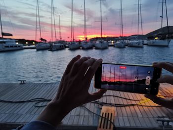 Cropped hand of man holding boat