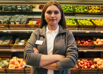 Portrait of young woman sitting at market
