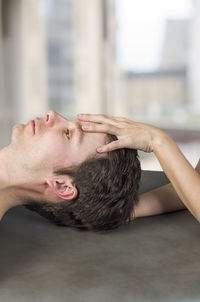 Cropped image of masseur massaging man in spa