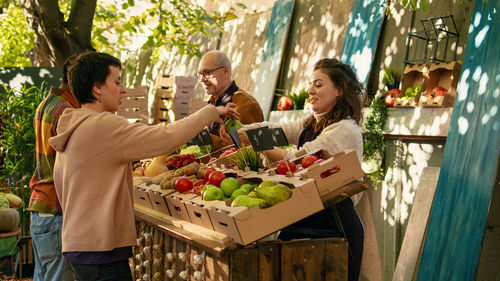 Rear view of woman holding food at restaurant