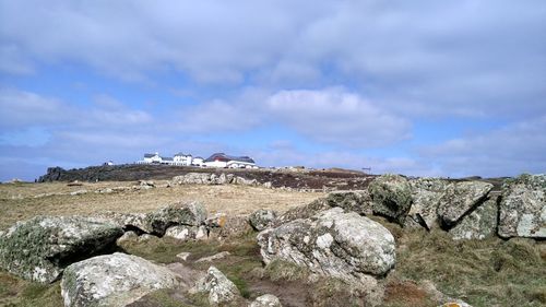 Panoramic view of rocks on land against sky