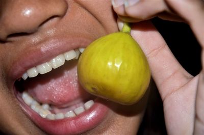 Close-up midsection of girl holding fig