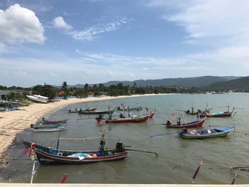 Boats moored on sea against sky