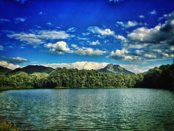 Scenic view of lake against cloudy sky