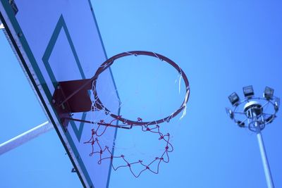 Low angle view of basketball hoop against blue sky