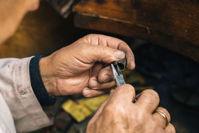 Close-up of man hand holding wood