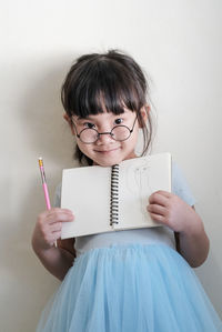 Portrait of woman holding book