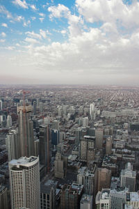 High angle view of modern buildings in city against sky