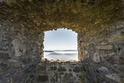 Scenic view of sea seen through arch