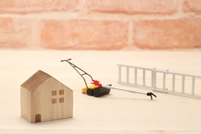 Close-up of toy on table against wall