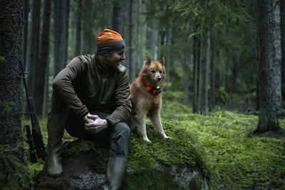 Hunter with dog in forest