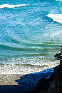 Close-up of wave on beach against sky