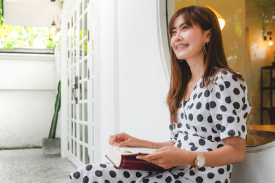 Portrait of young woman smiling at home