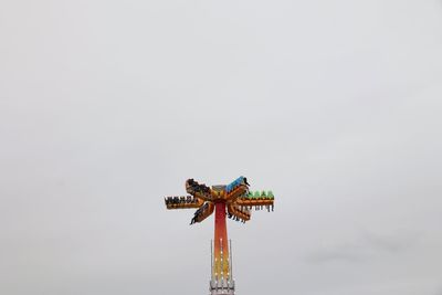 Low angle view of amusement park ride against sky