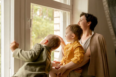 Happy grandmother and her grandsons enjoy time together. positive middle age woman