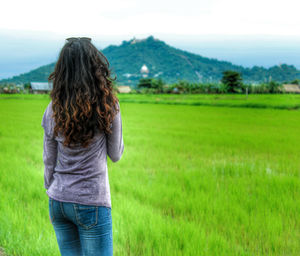 Rear view of woman standing on landscape